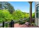 Scenic view from the porch, showcasing lush green trees, stately columns, and inviting steps at 2808 Broughton Se Ln, Atlanta, GA 30339