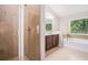 Bathroom featuring tiled shower, soaking tub, vanity and natural light from a window at 362 Lanier Ct, Hiram, GA 30141