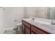 Bathroom featuring dual sinks, wood cabinets, a toilet and a mirror at 362 Lanier Ct, Hiram, GA 30141