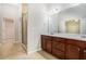 This bathroom is complete with dual sinks and a tiled floor and shower at 362 Lanier Ct, Hiram, GA 30141