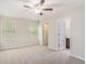 This bright bedroom features neutral carpet, a ceiling fan and an ensuite bathroom at 362 Lanier Ct, Hiram, GA 30141