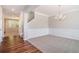 Elegant dining room with carpet, wainscoting detail, crown molding, and a modern chandelier at 362 Lanier Ct, Hiram, GA 30141