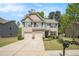 Charming two-story home with a well-manicured lawn and a two-car garage on a sunny day at 362 Lanier Ct, Hiram, GA 30141