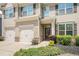 Inviting home featuring a covered front porch and attached two-car garage with well-maintained landscaping at 362 Lanier Ct, Hiram, GA 30141