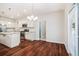 Bright kitchen with island, stainless steel appliances, and hardwood floors leading to the dining area at 362 Lanier Ct, Hiram, GA 30141