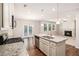 Open kitchen with granite island, stainless appliances, and connection to a cozy living area at 362 Lanier Ct, Hiram, GA 30141