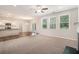 Open-concept living area with fireplace, flowing into a kitchen with bar seating and bright natural light at 362 Lanier Ct, Hiram, GA 30141