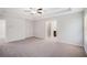 Neutral carpet, walls and ceiling fan define this main bedroom with ensuite bathroom at 362 Lanier Ct, Hiram, GA 30141