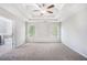 Spacious main bedroom features a tray ceiling, ceiling fan, and two bright windows at 362 Lanier Ct, Hiram, GA 30141