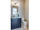 Chic powder room with navy vanity, marble countertop, modern mirror, and stylish fixtures at 3960 Clairmont Rd # 2, Chamblee, GA 30341