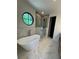 Stunning bathroom featuring soaking tub, glass shower, and unique round window for natural light at 3960 Clairmont Rd # 2, Chamblee, GA 30341