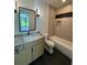 Bathroom featuring light-colored wood vanity, a tub, a decorative mirror, and tiled floors at 3960 Clairmont Rd # 2, Chamblee, GA 30341