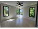 Bright bedroom with light hardwood floors, a ceiling fan, and large windows providing natural light and a view at 3960 Clairmont Rd # 2, Chamblee, GA 30341