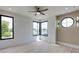 Bright bedroom featuring round window, modern lighting, and corner windows for natural light at 3960 Clairmont Rd # 2, Chamblee, GA 30341