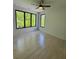 Bright bedroom with hardwood floors, a modern ceiling fan, and large windows overlooking greenery at 3960 Clairmont Rd # 2, Chamblee, GA 30341