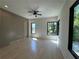 Bright bedroom with light wood floors, ceiling fan, and large windows with black frames at 3960 Clairmont Rd # 2, Chamblee, GA 30341