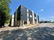 Modern townhome exterior with brick and dark metal siding, featuring large windows and new sidewalk at 3960 Clairmont Rd # 2, Chamblee, GA 30341
