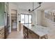 Bright kitchen with a walk-in pantry, marble island with a built-in microwave and adjacent staircase at 3960 Clairmont Rd # 2, Chamblee, GA 30341