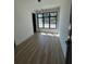 Bright room featuring hardwood floors, a modern chandelier, and big windows at 3960 Clairmont Rd # 2, Chamblee, GA 30341