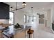 Open-concept living space with modern lighting, large windows, and hardwood floors adjoining the kitchen at 3960 Clairmont Rd # 2, Chamblee, GA 30341