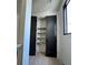 Pantry featuring dark doors, light hardwood floors, and organized shelving for ample storage at 3960 Clairmont Rd # 2, Chamblee, GA 30341