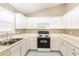 Well-lit kitchen with white cabinets, laminate countertops, and essential appliances at 4153 Island View Ct, Decatur, GA 30034