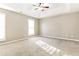 Spacious main bedroom features plush carpet, a ceiling fan, and abundant light at 4153 Island View Ct, Decatur, GA 30034