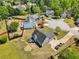 An aerial view showcases a gray house with a fenced backyard and spacious driveway in a desirable neighborhood at 1650 Willow River Run, Grayson, GA 30017