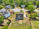 An aerial view of a gray home featuring a large backyard, fire pit, and ample parking in a cul-de-sac neighborhood at 1650 Willow River Run, Grayson, GA 30017