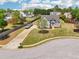 Aerial view of a charming home with a long driveway, lush lawn, and well-maintained landscaping in a serene neighborhood at 1650 Willow River Run, Grayson, GA 30017