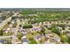 A wide aerial view showcasing a residential neighborhood adjacent to a highway and commercial area at 1650 Willow River Run, Grayson, GA 30017