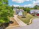 Aerial view showcasing a lovely home with a long driveway, expansive lawn, and well-maintained landscaping in a quiet neighborhood at 1650 Willow River Run, Grayson, GA 30017