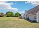 Expansive backyard featuring a well-maintained lawn, patio area, and privacy fence, perfect for outdoor entertaining at 1650 Willow River Run, Grayson, GA 30017