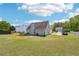 Large backyard view showcasing the home's siding, roof, and well-manicured lawn, offering ample space and privacy at 1650 Willow River Run, Grayson, GA 30017