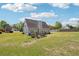 Beautiful backyard featuring a well-kept lawn, patio, and surrounding greenery, creating a serene outdoor oasis at 1650 Willow River Run, Grayson, GA 30017