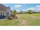 Wide backyard with a patio, established trees, bench, and sprawling lawn, perfect for Gathering gatherings and activities at 1650 Willow River Run, Grayson, GA 30017