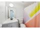 Bathroom with modern floors, sink with vanity, toilet and colorful shower curtain at 1650 Willow River Run, Grayson, GA 30017