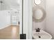 Elegant half bath with decorative mirror and fixtures, located near the living area at 1650 Willow River Run, Grayson, GA 30017