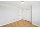 An empty bedroom features wood floors and a window at 1650 Willow River Run, Grayson, GA 30017