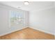 An empty bedroom features wood floors and a window at 1650 Willow River Run, Grayson, GA 30017