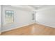 Bright bedroom with hardwood floors, tray ceilings, and natural light from two windows at 1650 Willow River Run, Grayson, GA 30017