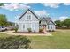 Two-story home with blue exterior, landscaped front yard, and a spacious driveway on a sunny day at 1650 Willow River Run, Grayson, GA 30017