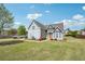 Lovely two-story blue home with manicured lawn, driveway, and beautiful blue sky at 1650 Willow River Run, Grayson, GA 30017