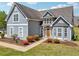 Inviting front exterior with a well-maintained lawn, vibrant landscaping, and a charming facade with stone detailing at 1650 Willow River Run, Grayson, GA 30017