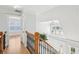 Upstairs hallway view features decorative railing and natural light at 1650 Willow River Run, Grayson, GA 30017