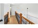 Second floor hallway view with wood railing and staircase to front entry at 1650 Willow River Run, Grayson, GA 30017