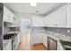 Modern kitchen featuring stainless appliances, marble countertops, and mosaic backsplash at 1650 Willow River Run, Grayson, GA 30017