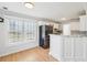 Charming eat-in kitchen featuring white cabinets, granite countertops, and stainless steel appliances at 1650 Willow River Run, Grayson, GA 30017