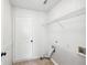 Functional laundry room with connections for washer and dryer and additional storage shelf at 1650 Willow River Run, Grayson, GA 30017