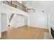 Bright living room features hardwood floors, fireplace, and a chandelier at 1650 Willow River Run, Grayson, GA 30017